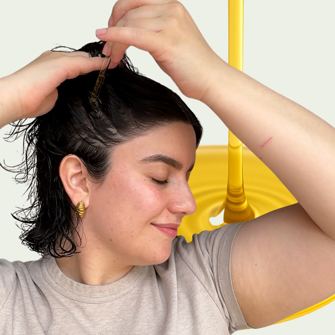 Image of someone applying hair oil for a complete guide to the best carrier oils for every hair type