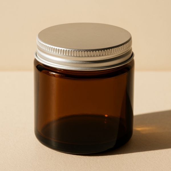 Amber Glass Jar with Silver Cap on a beige background