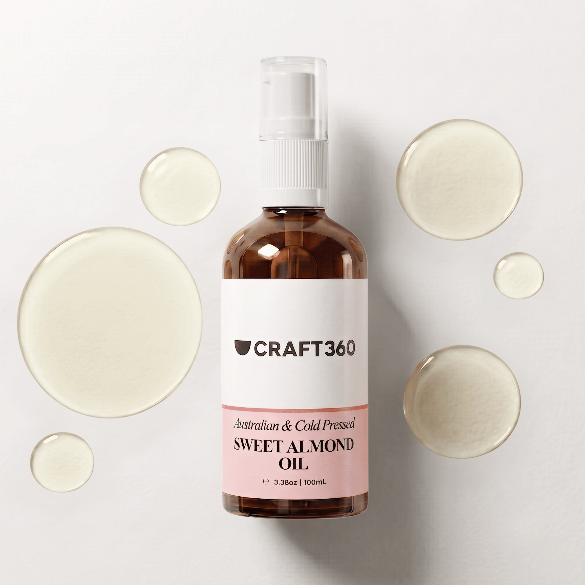 100 ml bottle of Australian Sweet Almond Oil surrounded by pools of pale golden oil