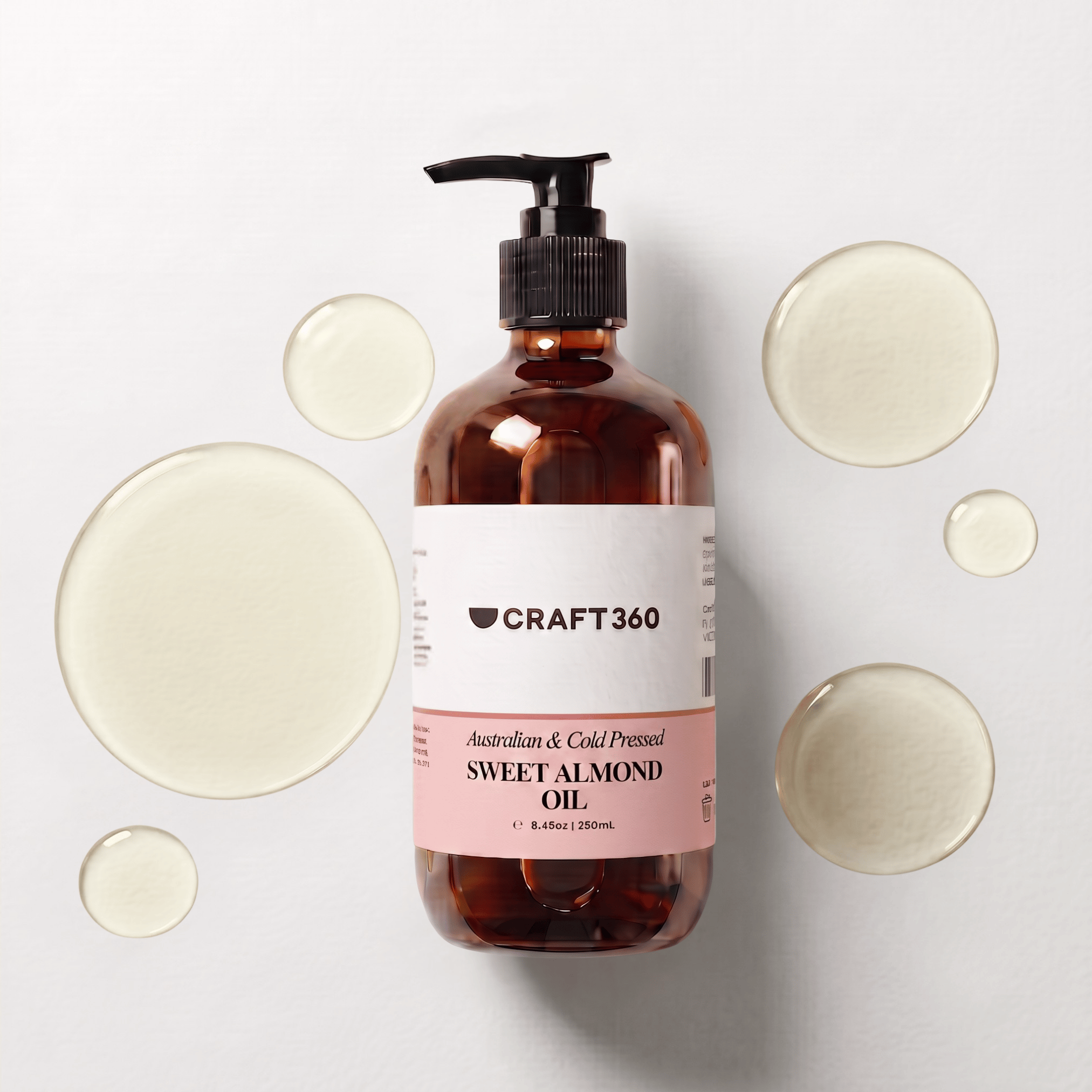 250 ml bottle of Australian Sweet Almond Oil surrounded by pools of pale golden oil