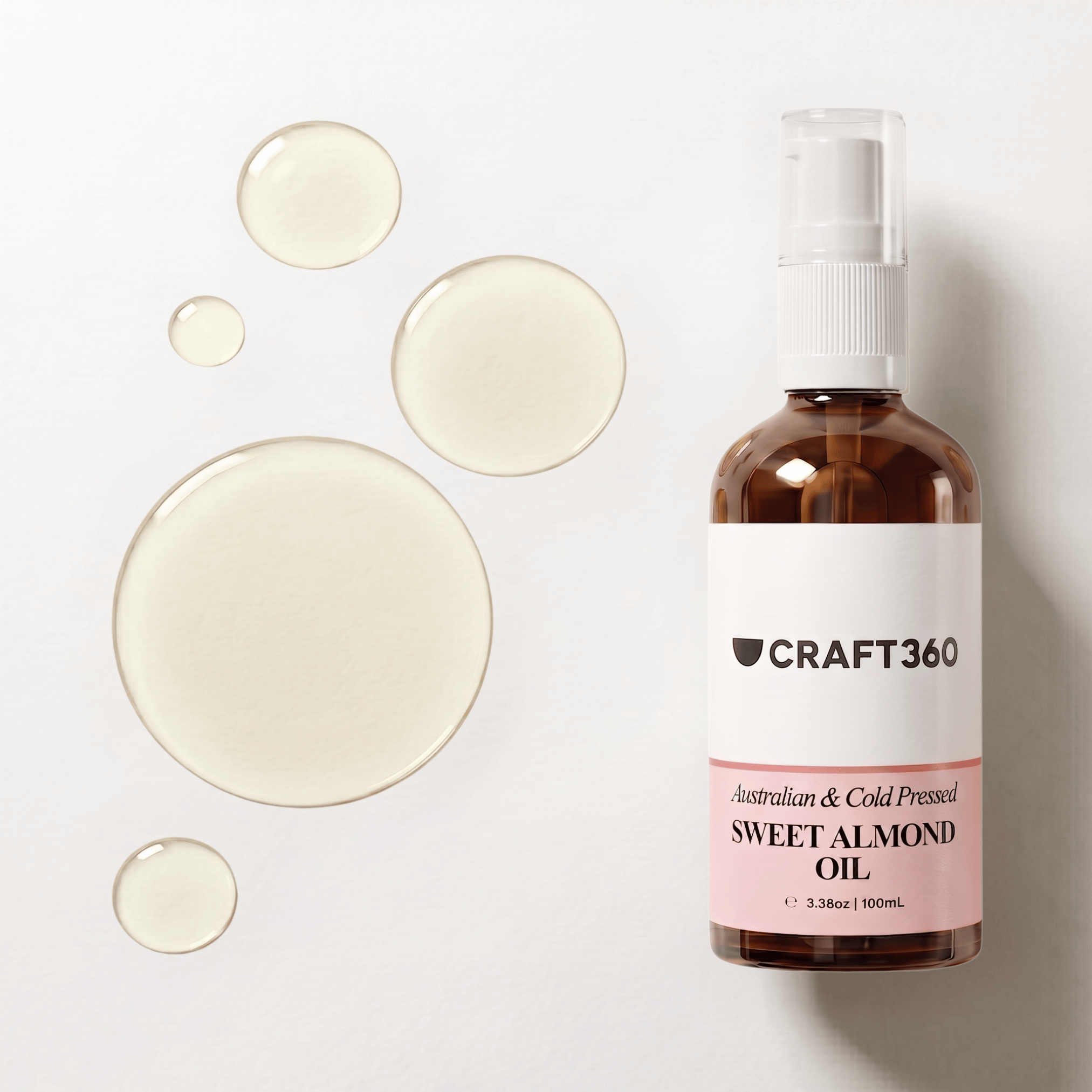 Australian Sweet Almond Oil in a Craft 360 amber glass pump bottle with oil droplets