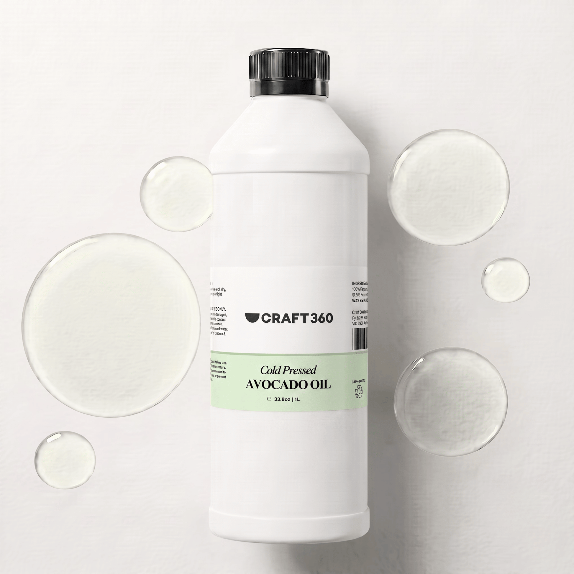 1 L bottle of Avocado Oil surrounded by pools of natural carrier oil