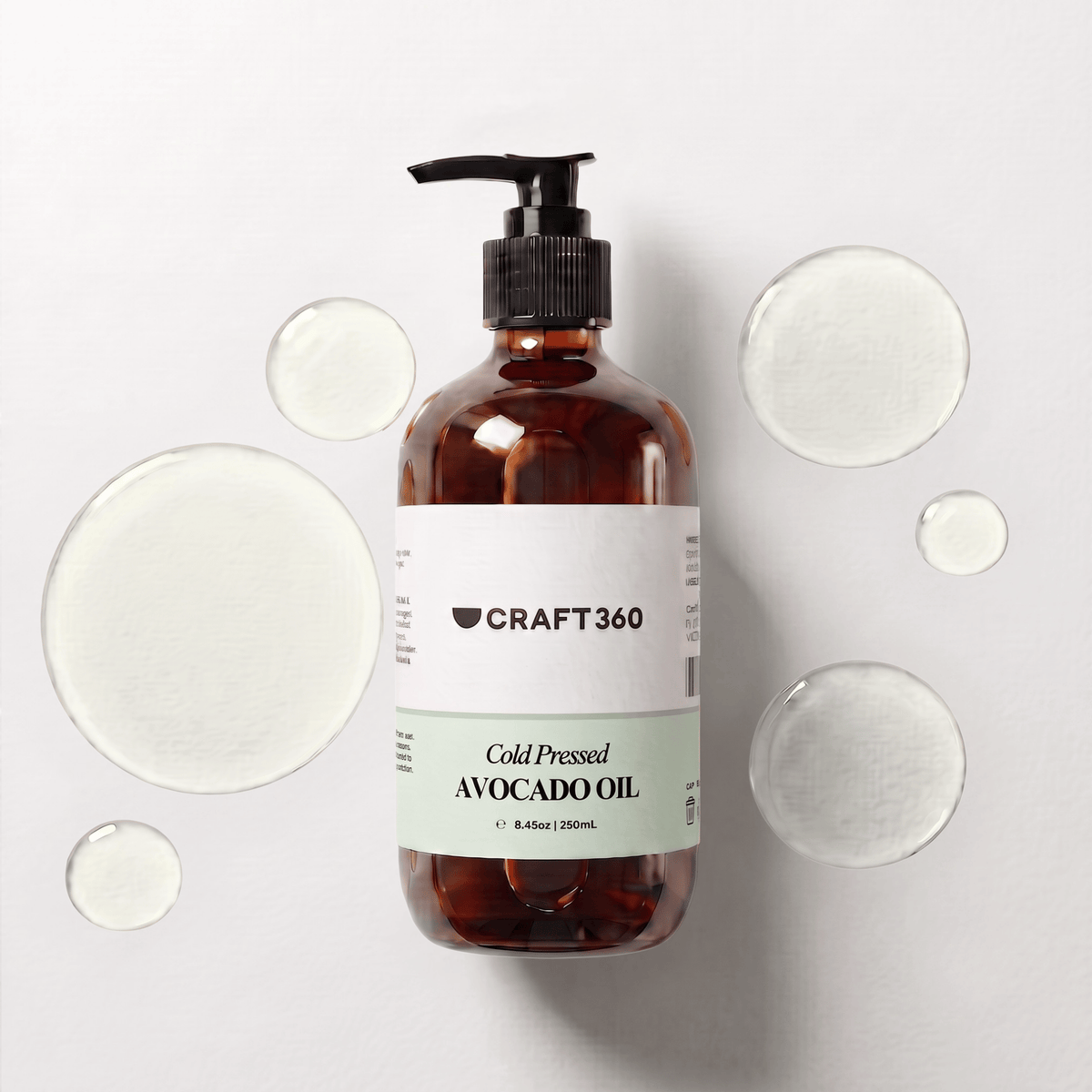250 ml bottle of Avocado Oil surrounded by pools of natural carrier oil