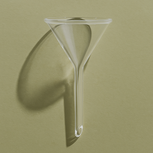 Clear glass funnel on a green background