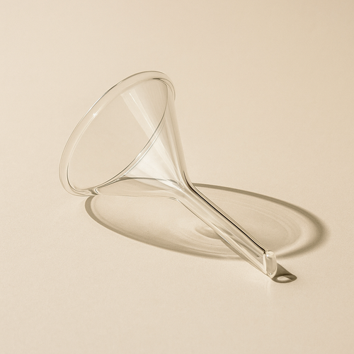Clear glass funnel on a beige background