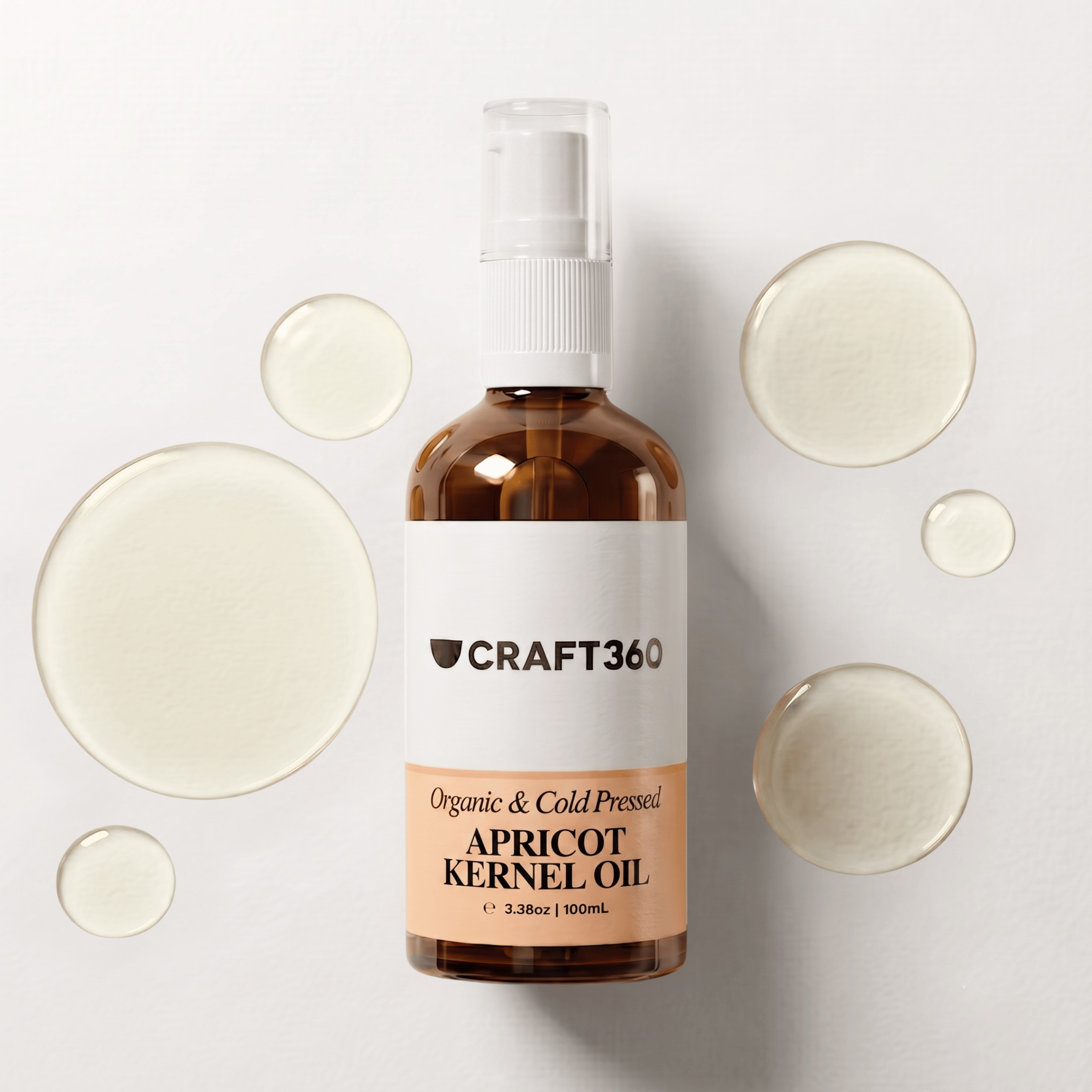 100 ml bottle of Apricot Kernel Oil surrounded by pools of pale golden oil