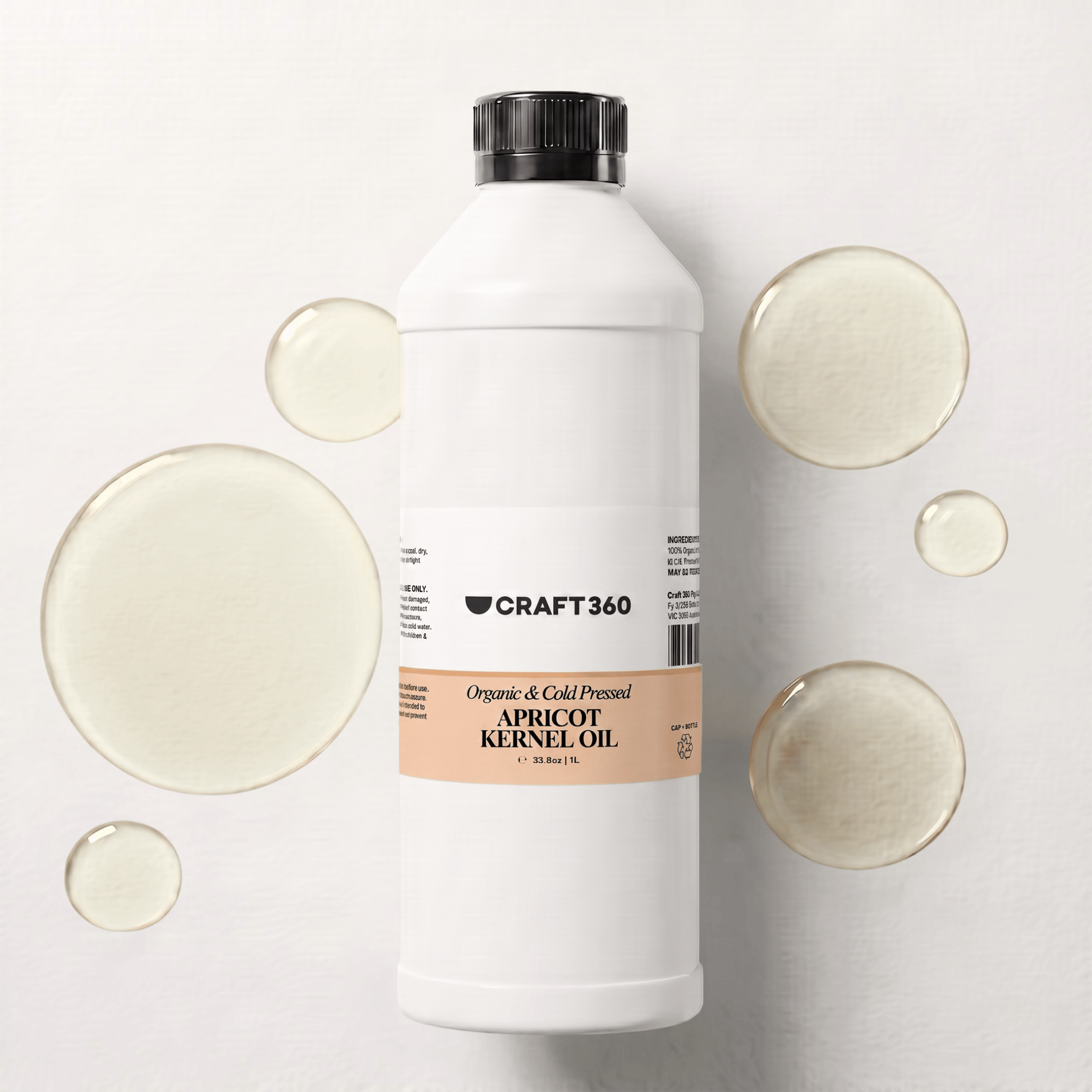 1 L bottle of Apricot Kernel Oil surrounded by pools of pale golden oil