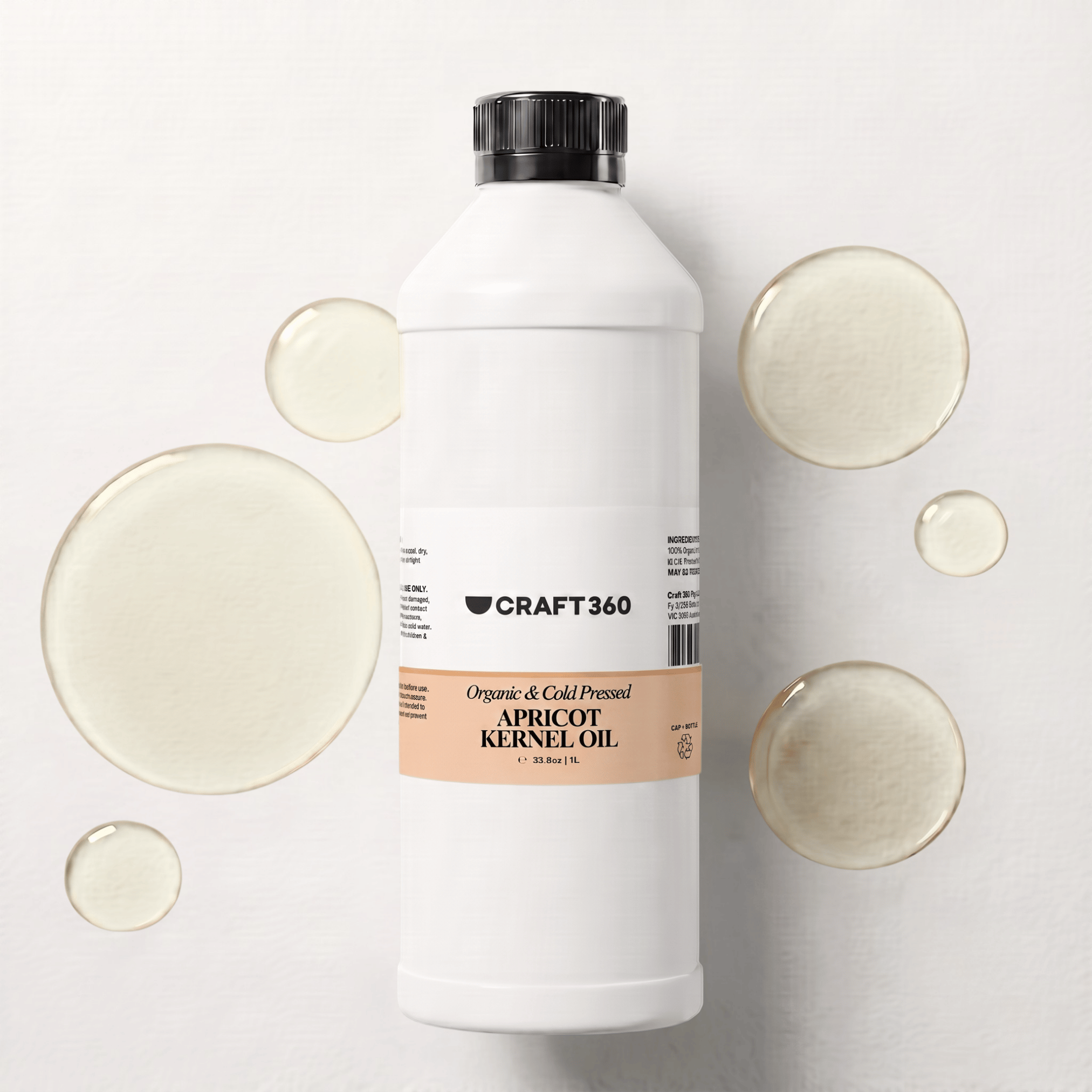 1 L bottle of Apricot Kernel Oil surrounded by pools of pale golden oil