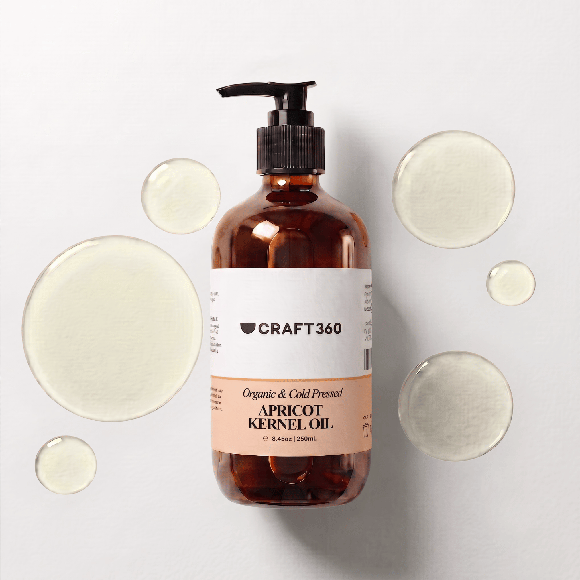 250 ml bottle of Apricot Kernel Oil surrounded by pools of pale golden oil