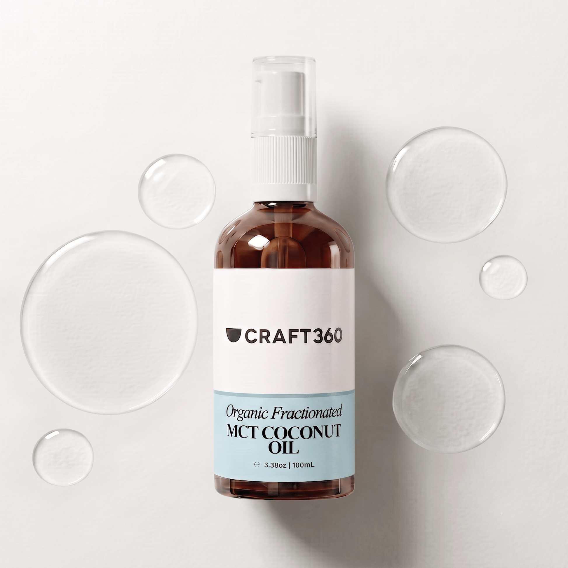 100 ml bottle of Organic Fractionated Coconut Oil surrounded by pools of clear carrier oil