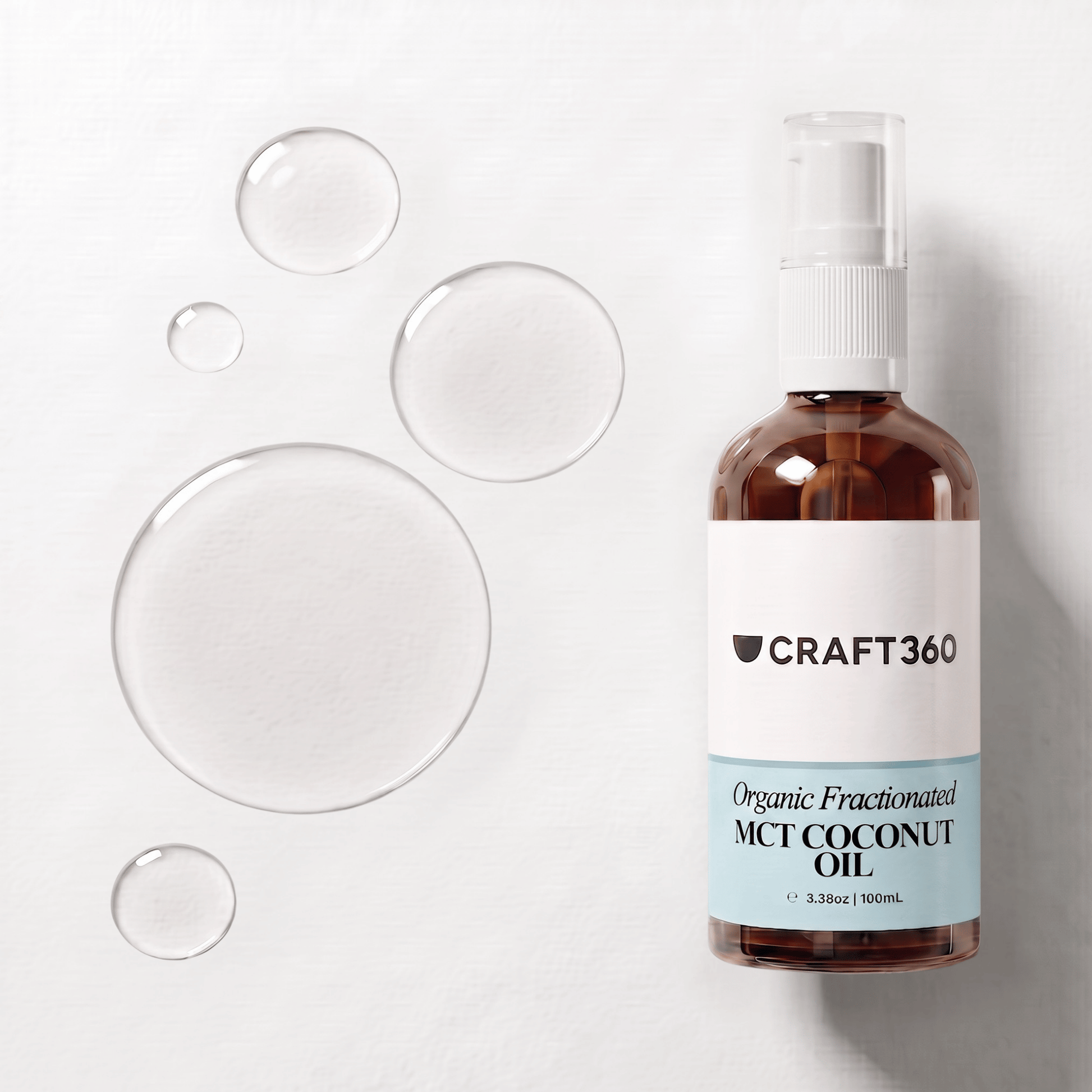 Organic Fractionated Coconut Oil in a Craft 360 amber glass bottle with clear oil droplets
